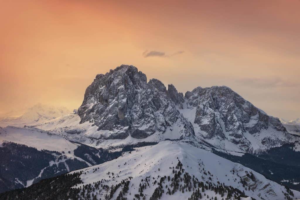 Snow-capped Sierra Vista mountain range with colorful sunset sky.