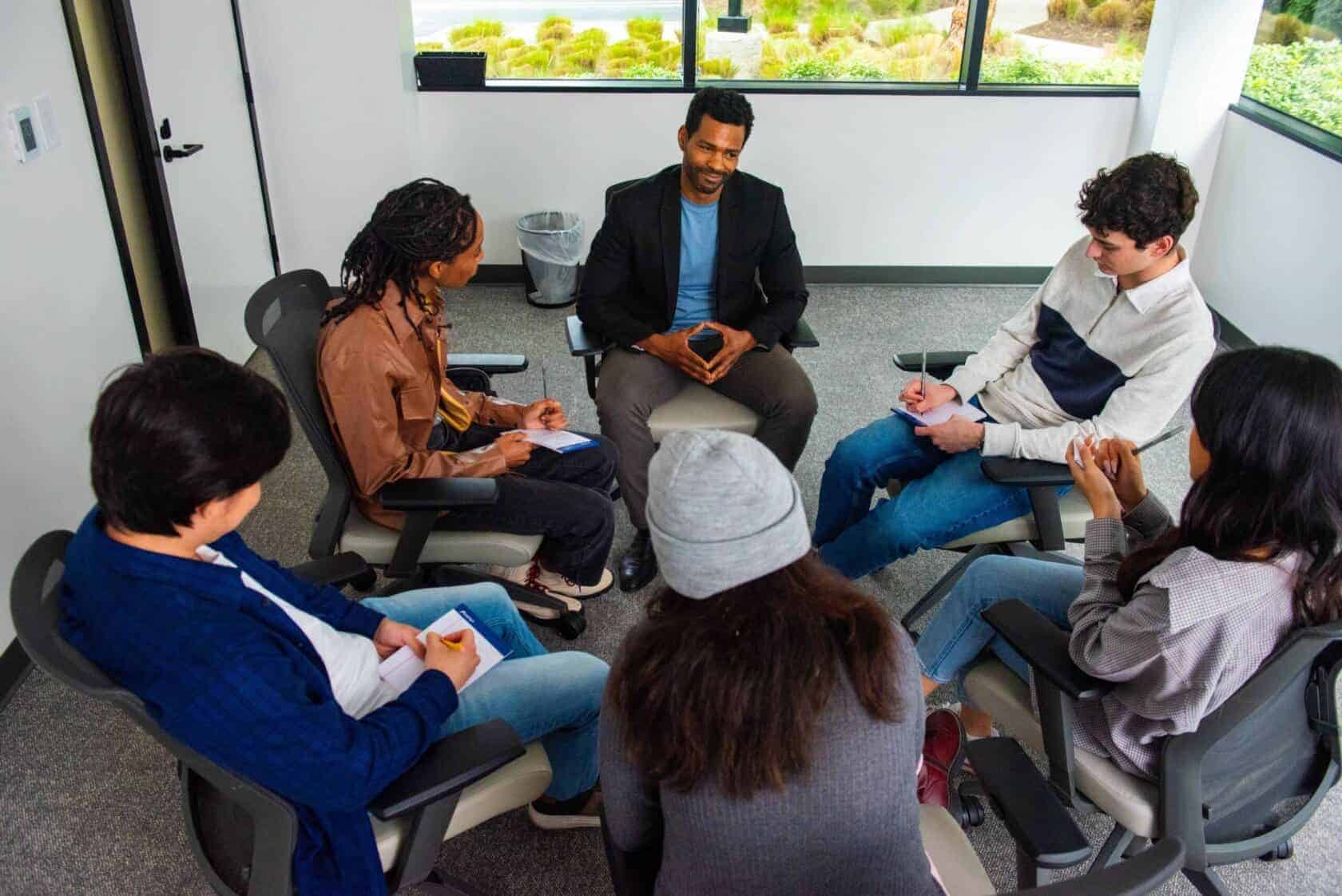 People collaborating during a team meeting at Sierra Vista office for business success and teamwork.